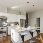 A beautifully refinished kitchen showcasing newly painted cabinets and fresh wall colors by Rendon Painting Inc.
