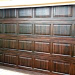 Custom faux-finished garage door on a luxury home in Naples, Florida